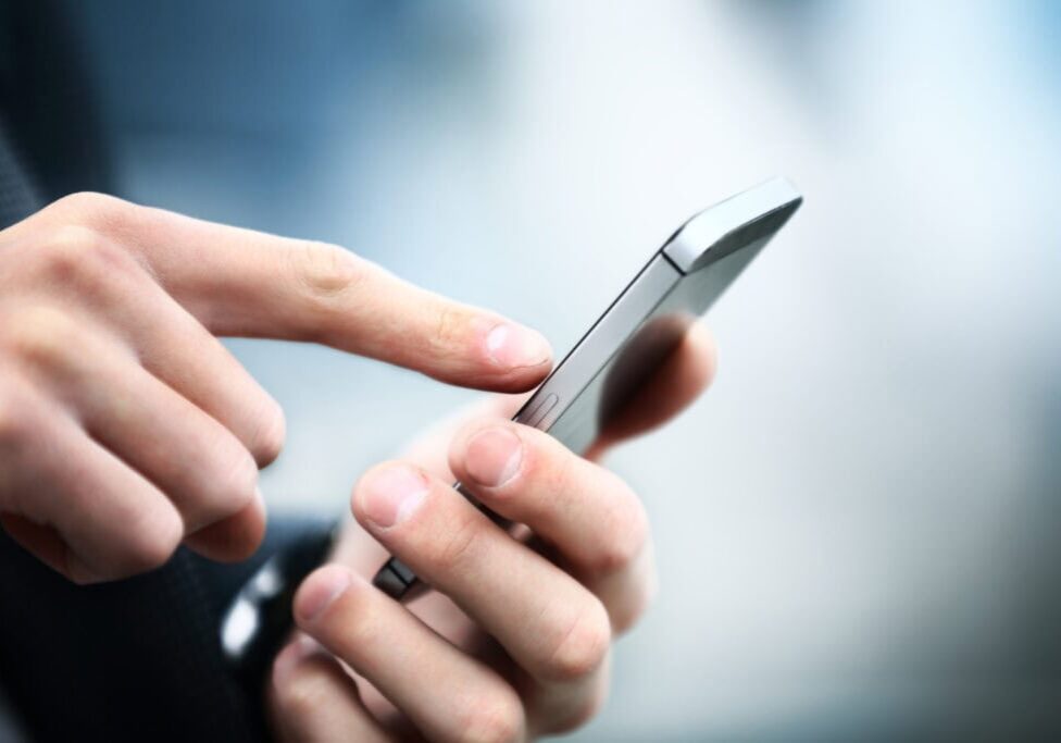 Close up of a man using mobile smart phone